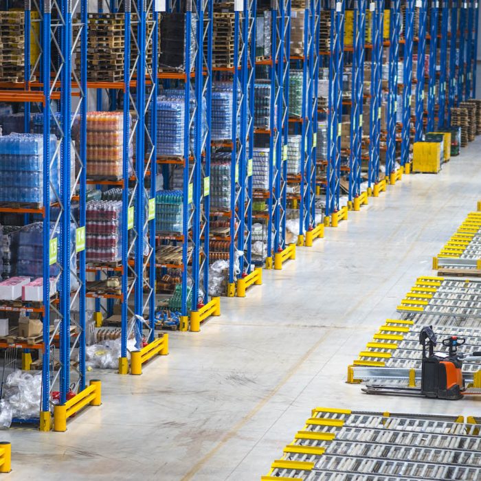 Distribution warehouse building interior and large storage area with goods on the shelf.